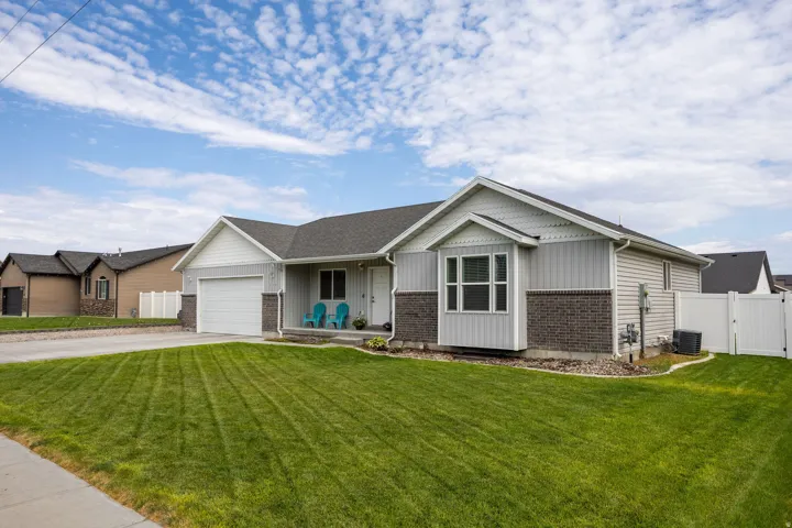 Exterior showcasing a combination of siding and brick detailing, a two-car garage, and a bay window feature