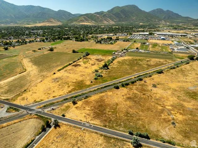Expansive land parcel featuring open fields and a clear sky backdrop