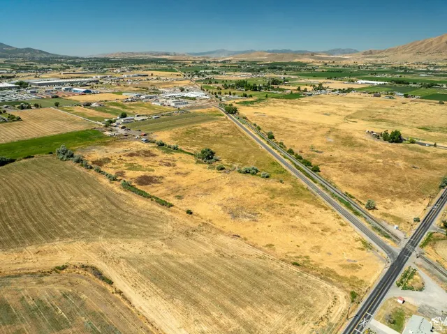 Expansive land parcels with mixed terrain, including cultivated fields and natural ground cover
