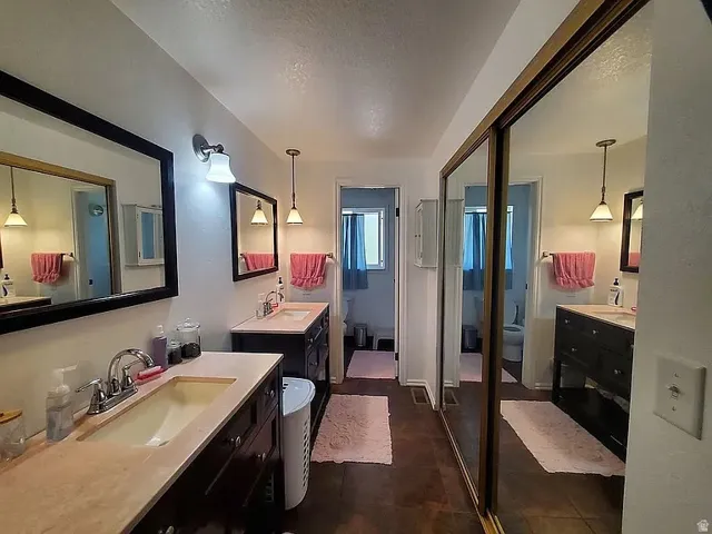 Dual vanities featuring undermount sinks and light-toned countertops