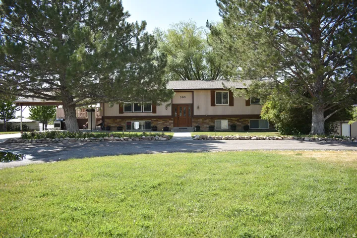 Split-level residence featuring a stone and siding facade