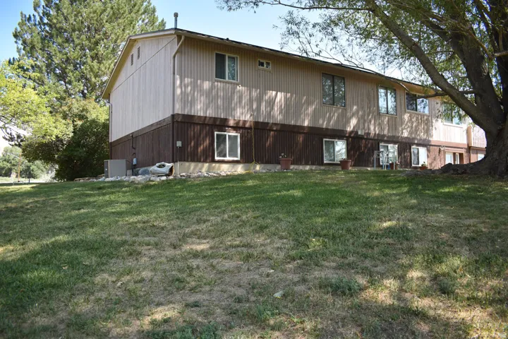 Two-story exterior with vertical wood siding and dark-stained paneling