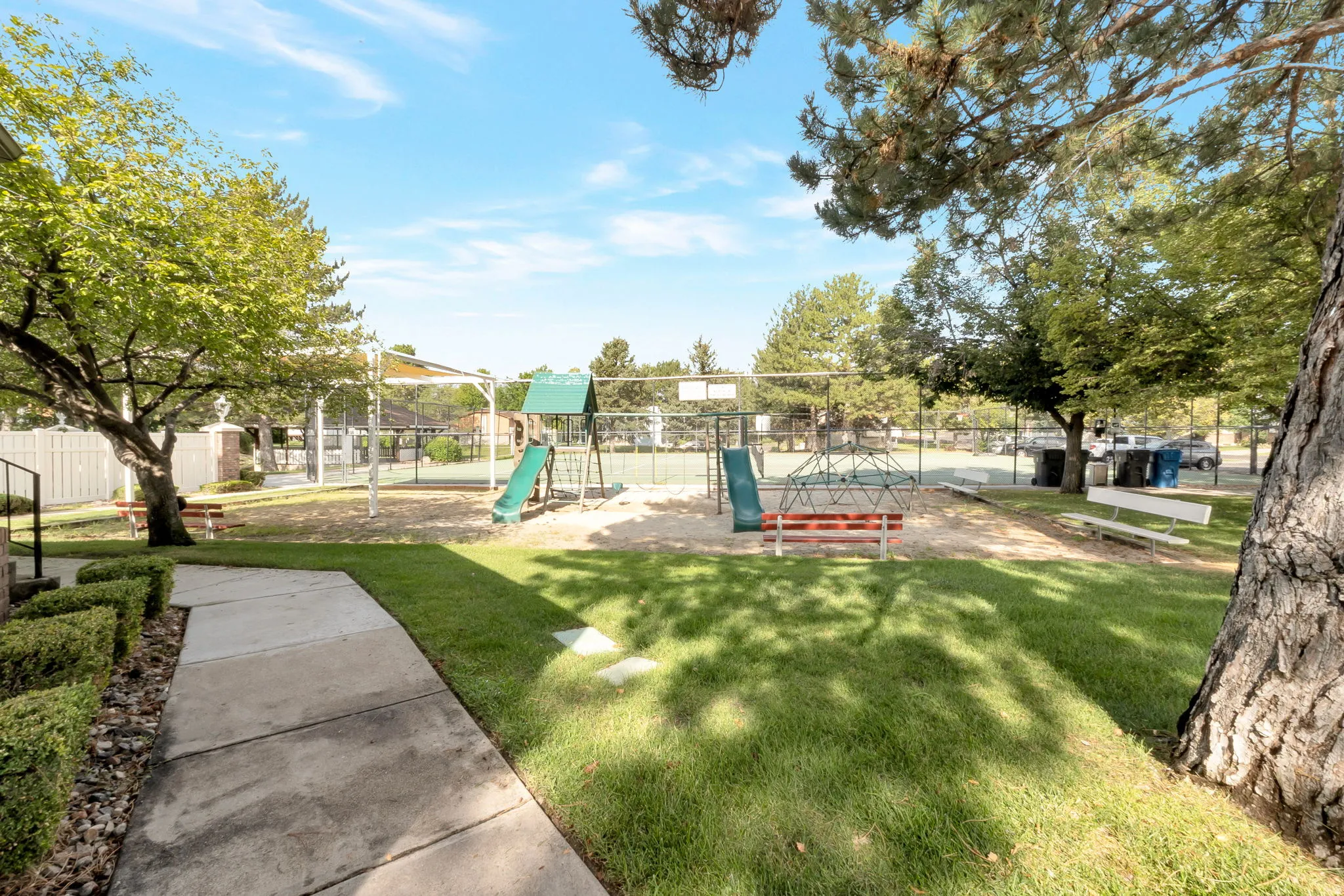 Community playground featuring slides, climbing structure, and benches