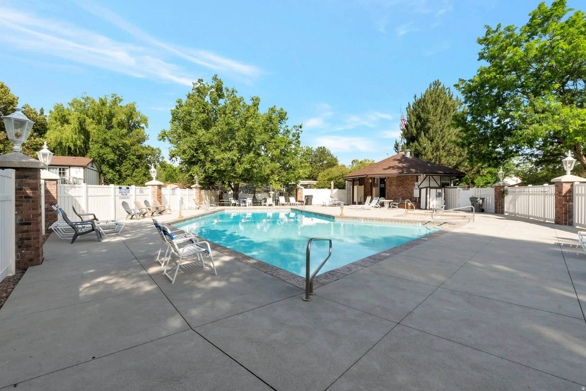 Rectangular swimming pool surrounded by a spacious concrete deck