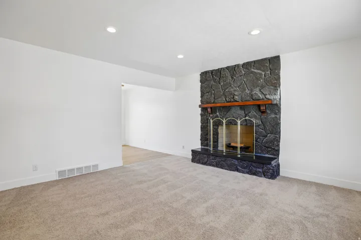 Stone fireplace with a wood mantel