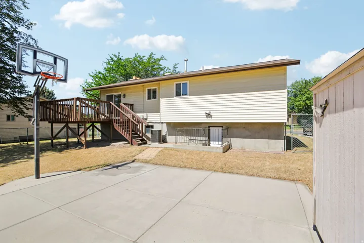 Spacious concrete patio with an adjustable basketball hoop