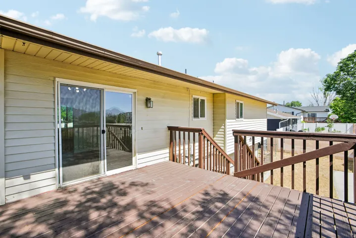 Expansive exterior deck featuring durable wood-finish flooring and sturdy railings