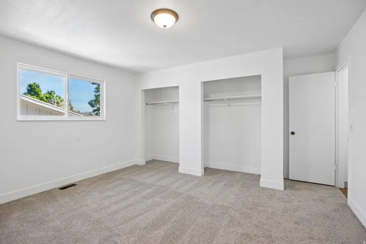 Room with neutral carpeting and white walls