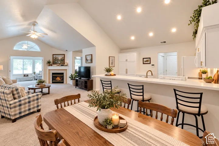 Vaulted ceiling with an arched transom window, built-in fireplace, and a kitchen island with seating