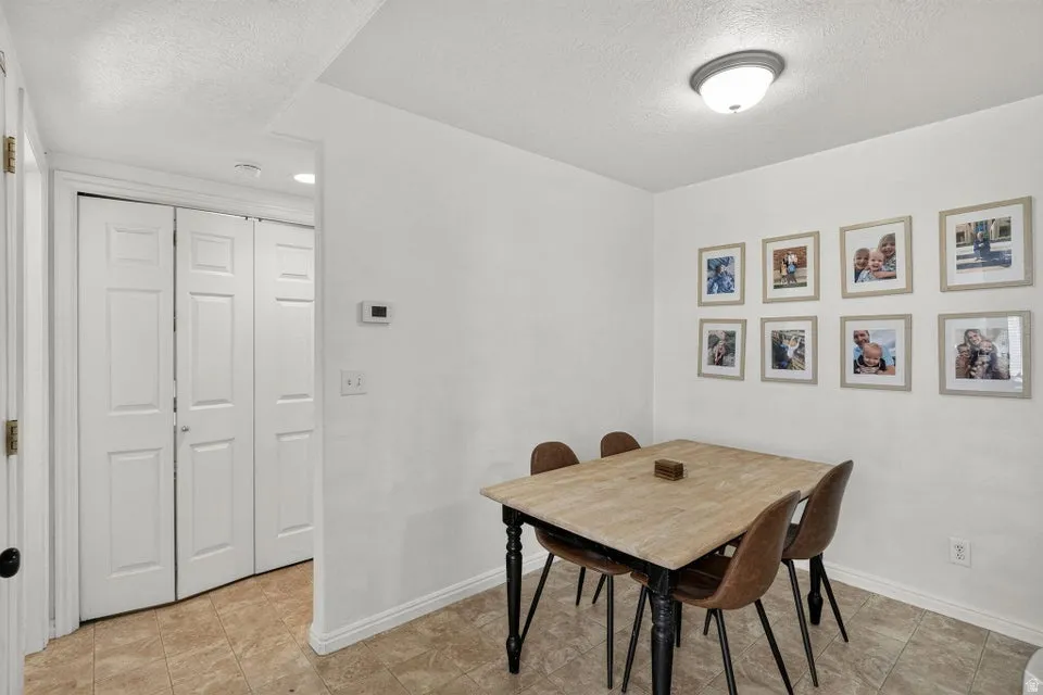 White walls with a textured ceiling and baseboard trim