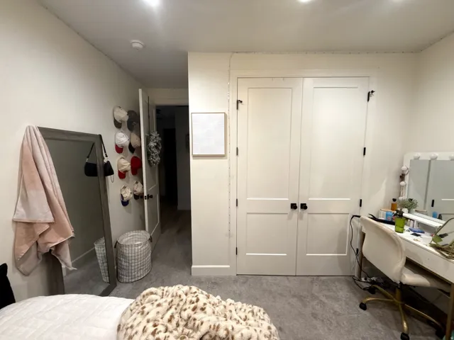 Double-door closet featuring panel construction and matte black hardware
