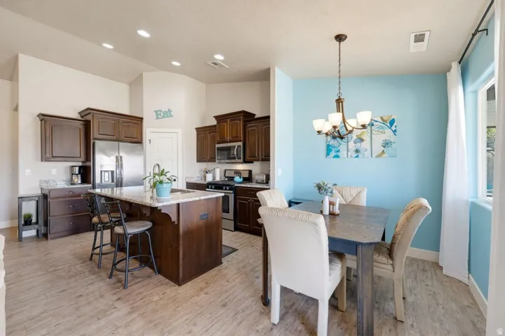 Open-concept kitchen and dining area featuring wood-finish flooring