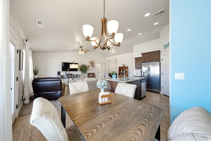 Dining area featuring wood-finish flooring and a bronze chandelier