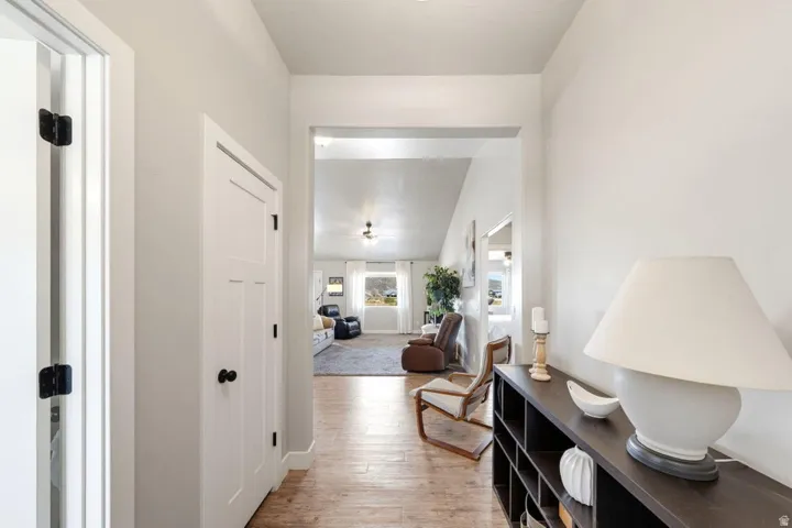 Hallway featuring wood-finish flooring and light-toned walls