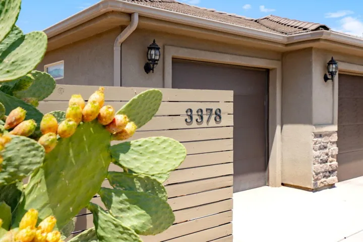 Stucco exterior with stone accents and two garage doors