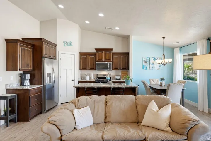 Open-concept living area featuring wood-finish flooring and vaulted ceilings