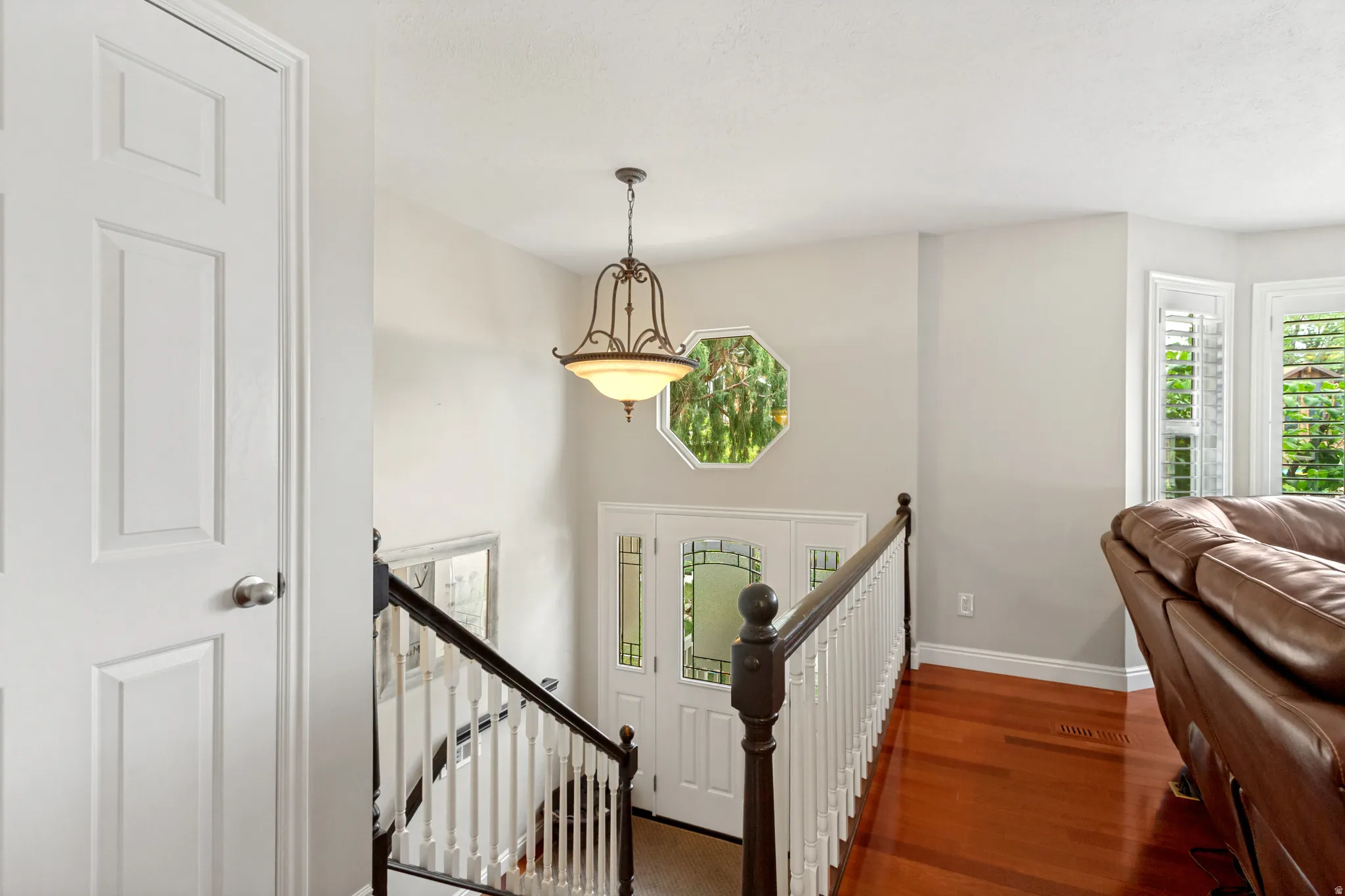 Entrance foyer with rich wood-finish flooring
