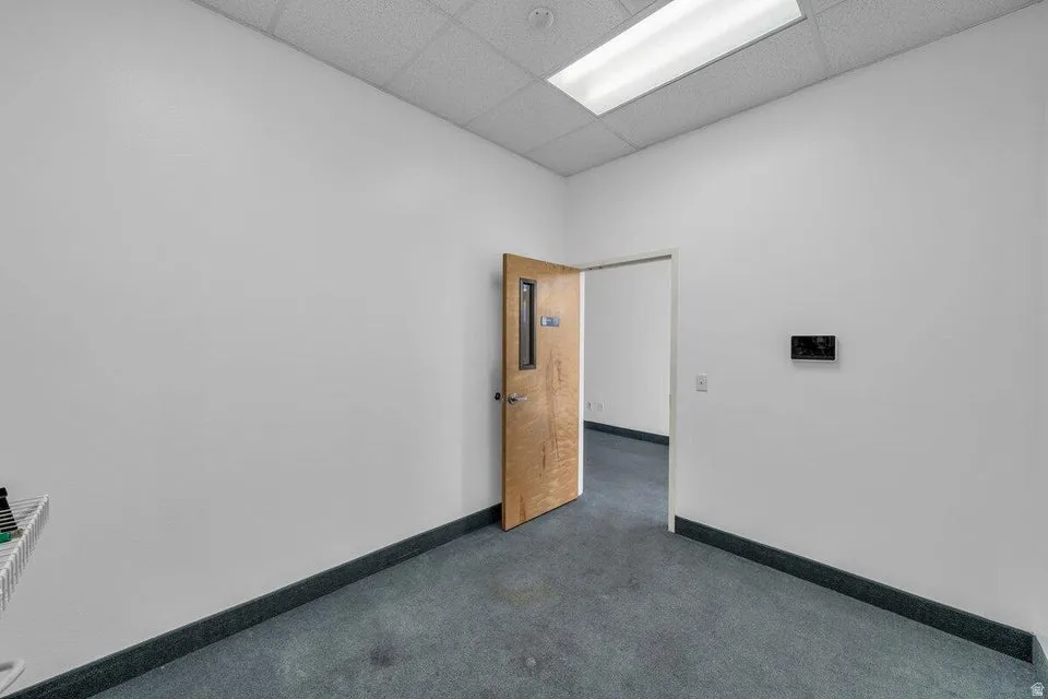 Room featuring white painted walls and gray carpet flooring