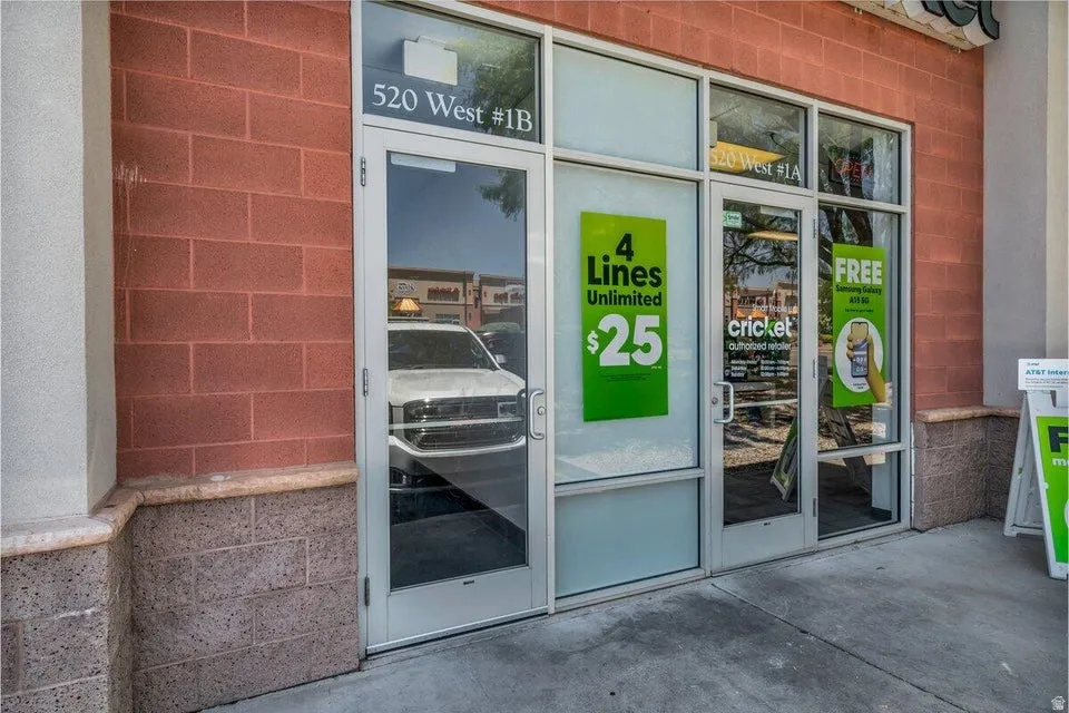 Commercial storefront featuring a red brick facade with a stone-finish base