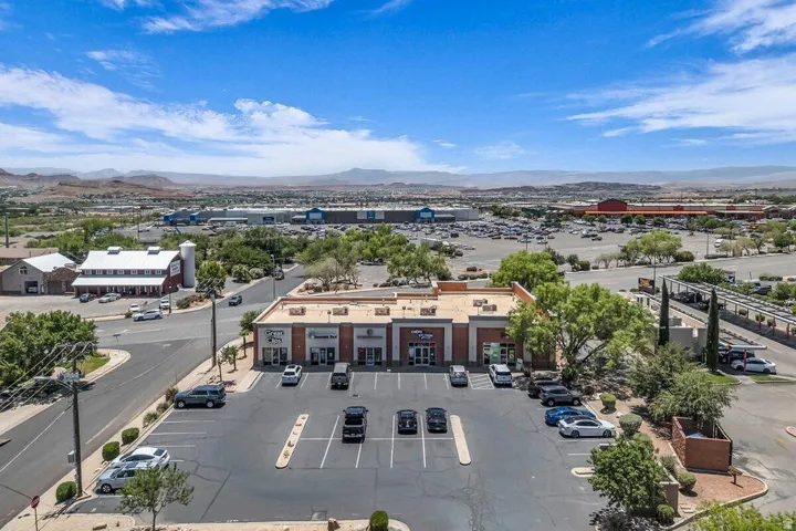 Commercial property featuring a brick facade and a dedicated parking lot