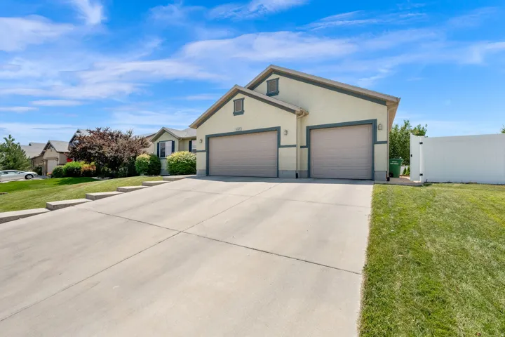 Stucco exterior with a pitched roof and a two-car garage
