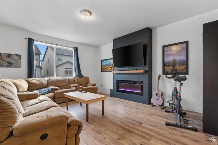 Living area featuring wood-finish flooring and a black shiplap accent wall