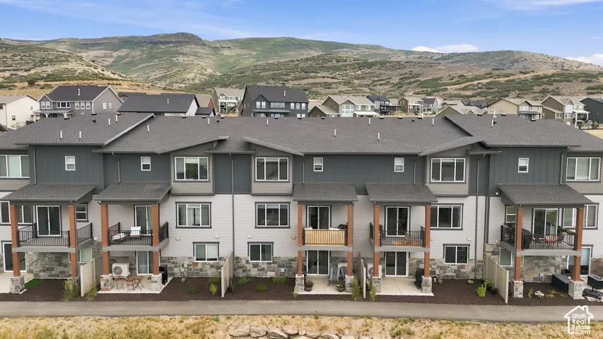 Contemporary townhome community featuring multi-level units with private patios and balconies