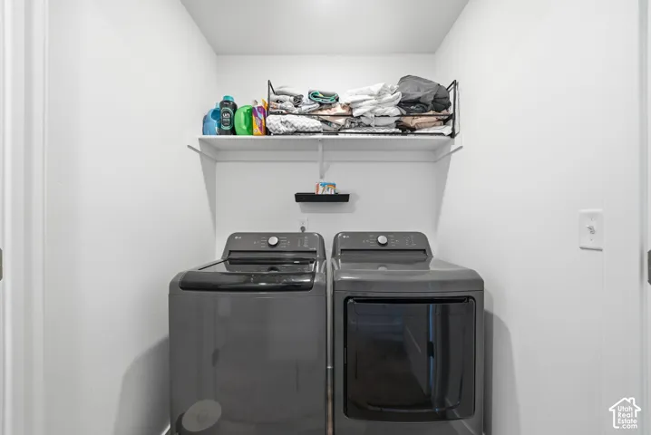 Dedicated laundry area featuring a built-in white shelf and overhead wire shelving