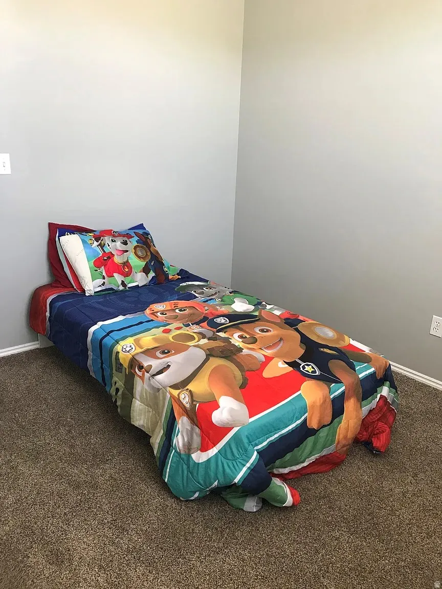 Carpeted bedroom with light gray walls and white trim
