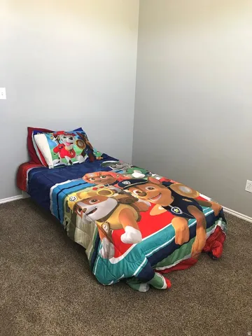 Carpeted bedroom with light gray walls and white trim