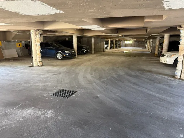 Covered parking garage featuring concrete flooring and structural support columns