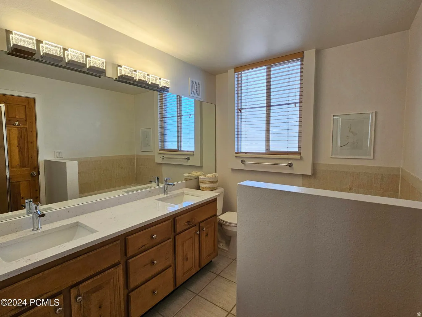 Double vanity with undermount sinks and chrome fixtures