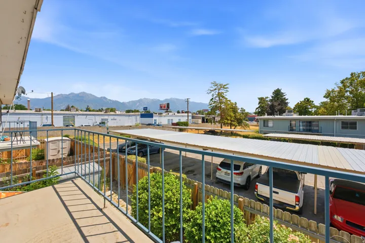 Balcony with metal railing and concrete flooring offering mountain scenery