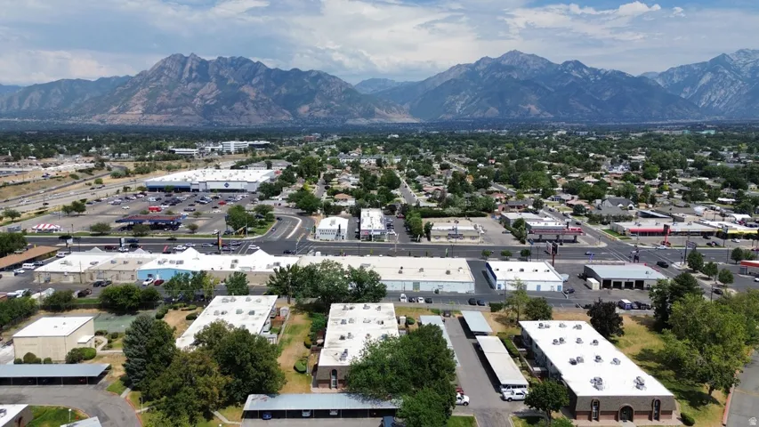 Aerial perspective showcasing multiple commercial buildings and residential structures