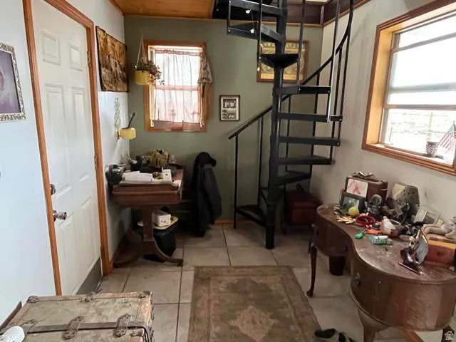 Black metal spiral staircase with wood-finish flooring