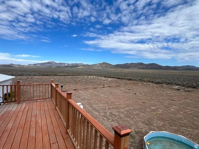 Wood-finish decking with railings offering expansive desert and mountain scenery