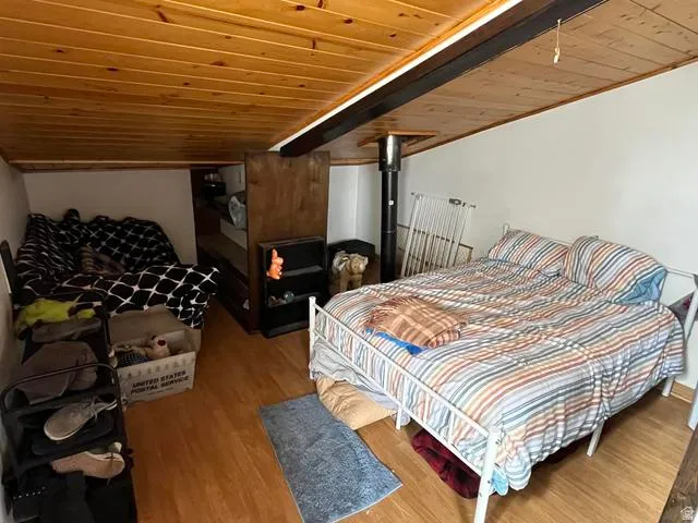 Vaulted wood-paneled ceiling with exposed beam