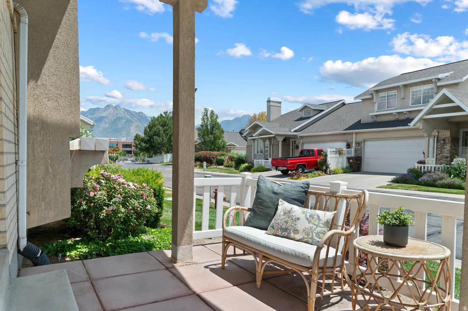 Covered porch featuring concrete pavers and a white railing