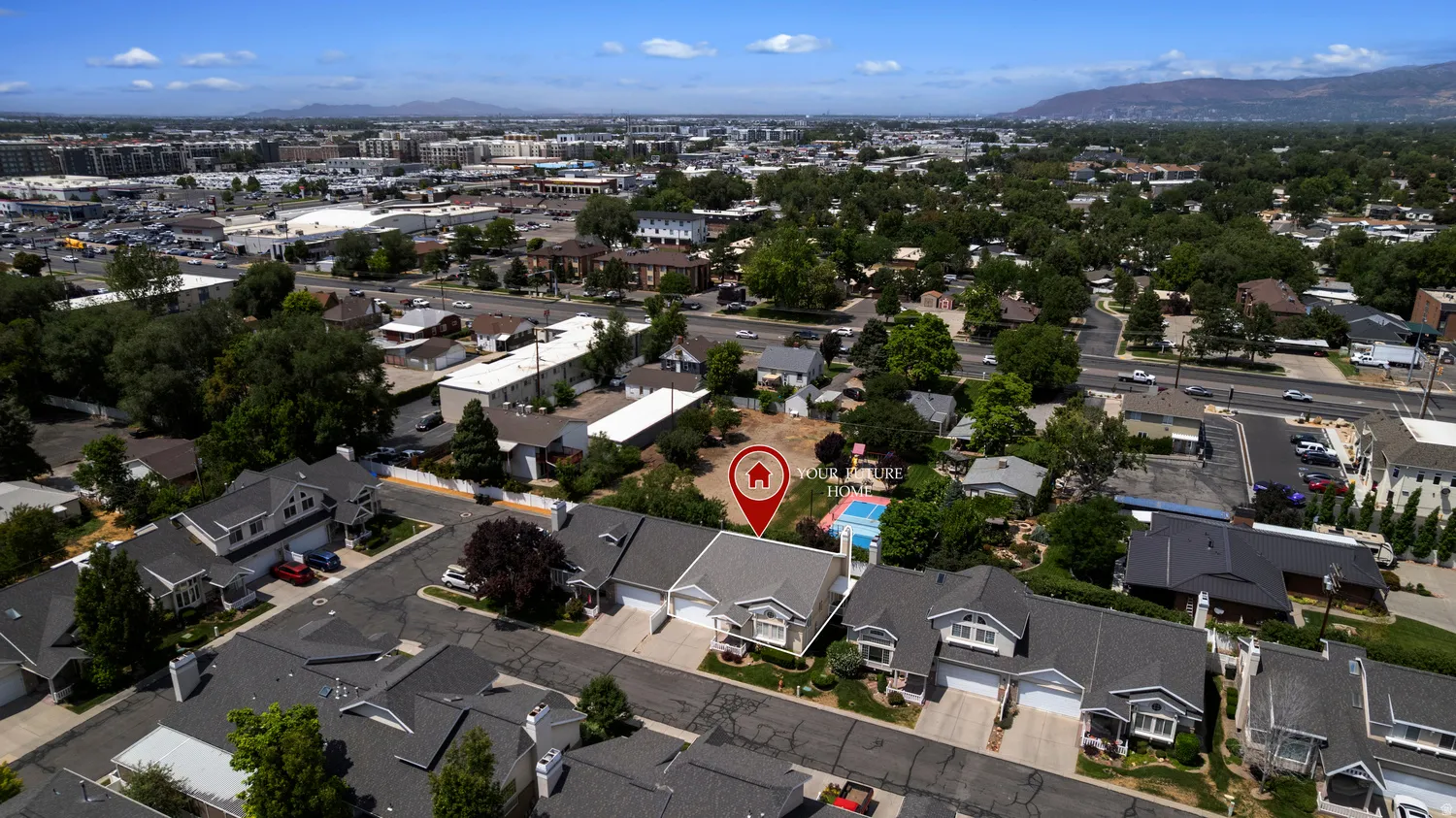 Residential property situated within an established neighborhood, featuring a classic roofline and a paved driveway