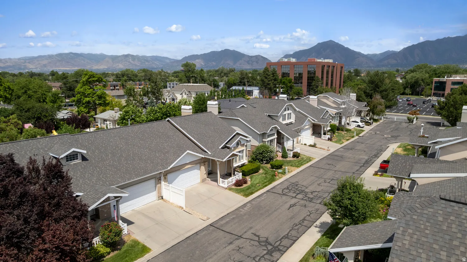 Aerial perspective showcasing a residential street lined with multi-story homes featuring attached garages