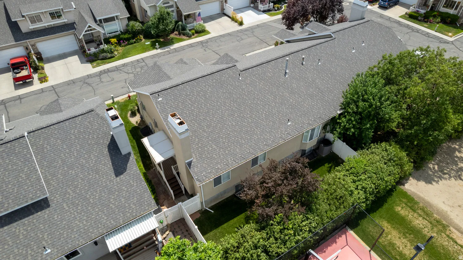 Aerial perspective showcasing the residential complex with shingle roofs and mature landscaping