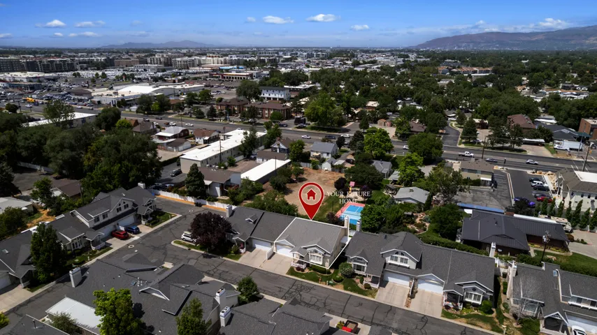 Residential property situated within an established neighborhood, featuring a classic roofline and a paved driveway