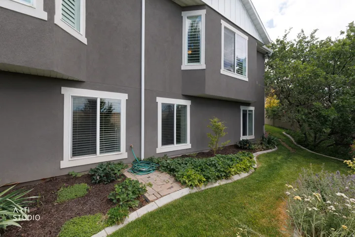 Stucco exterior with white trim windows
