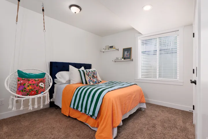 Carpeted room featuring a window with white blinds, white trim, a flush mount ceiling light, and a recessed ceiling light