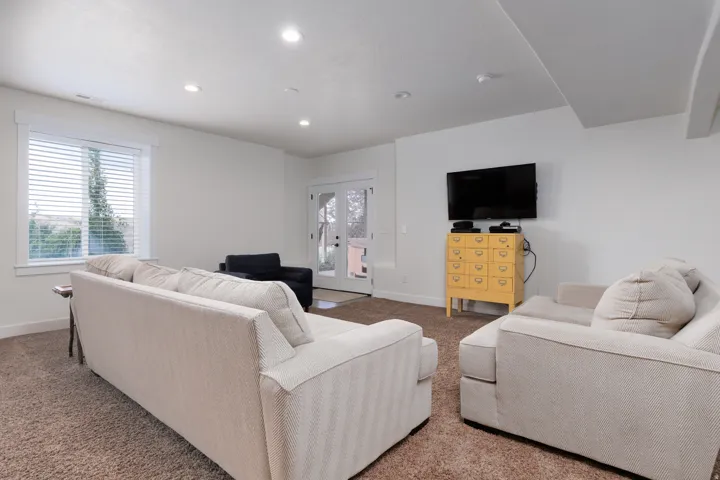 Spacious room featuring neutral carpeting and white walls