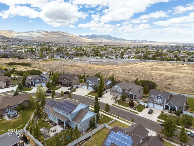 Residential neighborhood featuring varied single-family homes, mature landscaping, and solar panel installations on select roofs