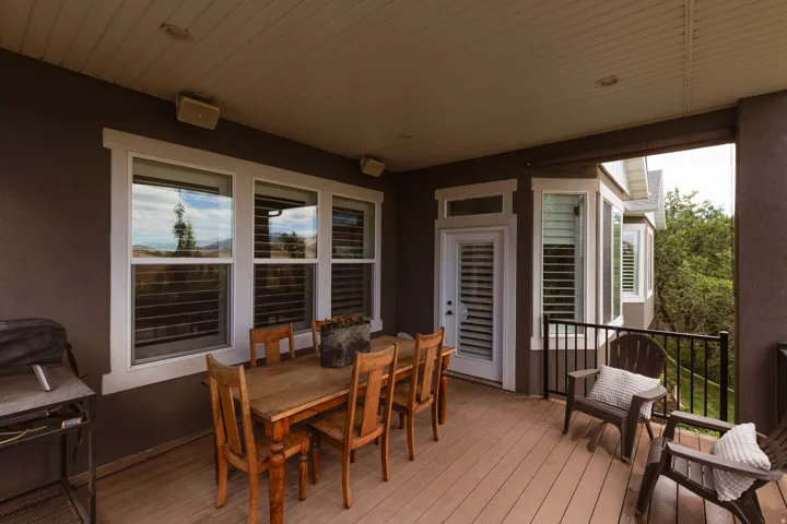 Covered outdoor deck with light brown plank flooring