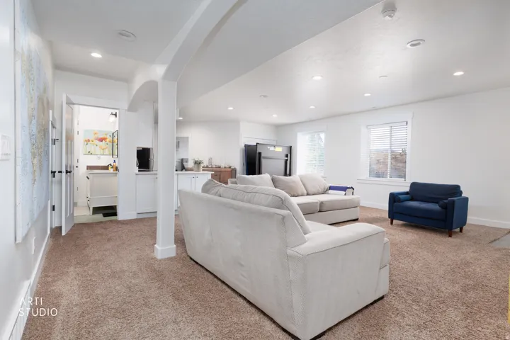 Open-concept living area featuring recessed lighting and neutral-toned carpeting