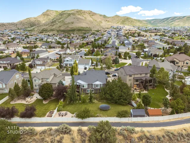 Residential neighborhood with homes featuring varied architectural styles and a mountainous backdrop