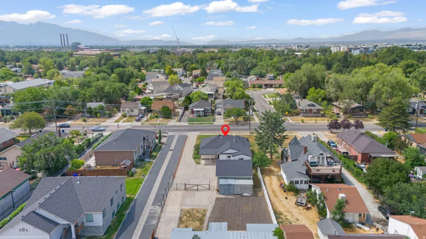 Aerial perspective of a neighborhood featuring mature trees and established residential properties